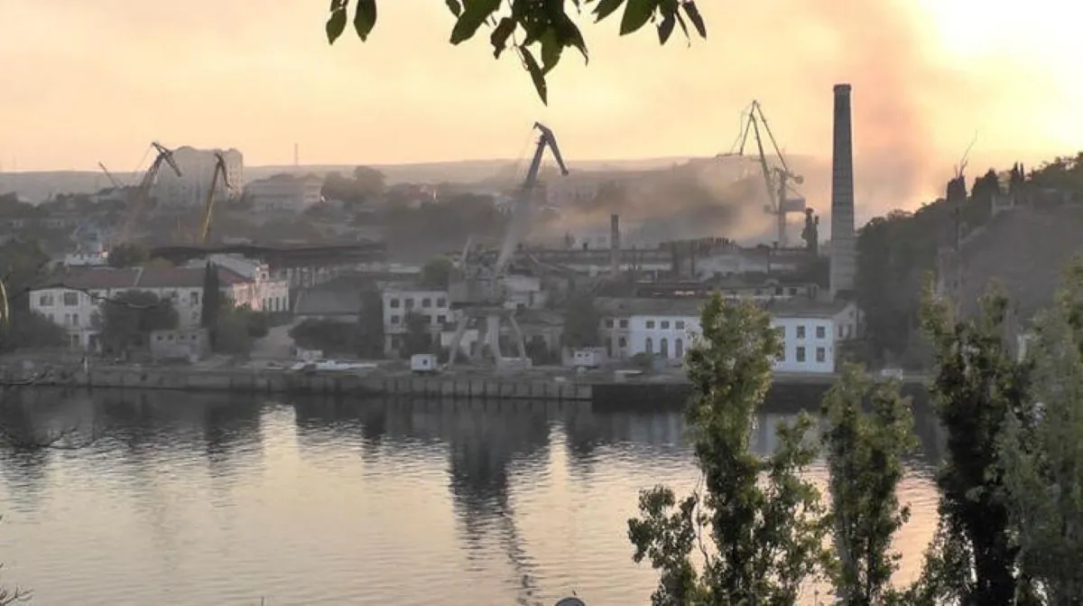 Smoke rises from the shipyard that was hit by Ukrainian missile attack in Sevastopol, Crimea, in this still image from video taken on Sept. 13, 2023. (Reuters TV via Reuters)