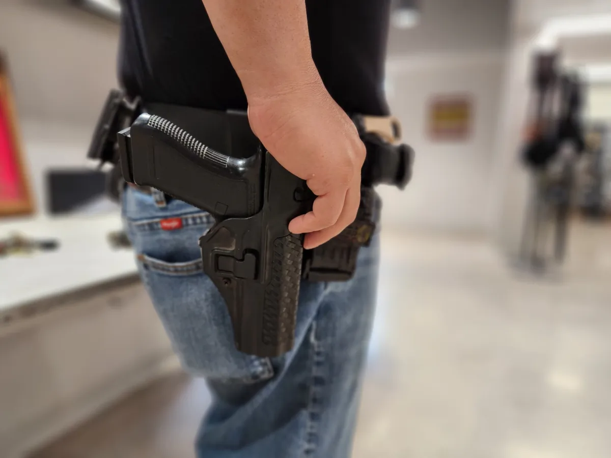 Luke Saiz of Albuquerque, N.M., with a Glock 9mm handgun at a local gun shop on Sept. 12, 2023. (Allan Stein/The Epoch Times)