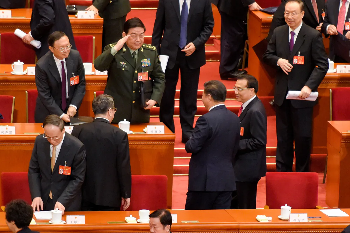 A high rank military officer gives a military salute to Chinese President Xi Jinping (C) and Premier Li Keqiang (R) after the opening session of the National People's Congress at The Great Hall of People on March 5, 2017 in Beijing, China. (Etienne Oliveau/Getty Images)