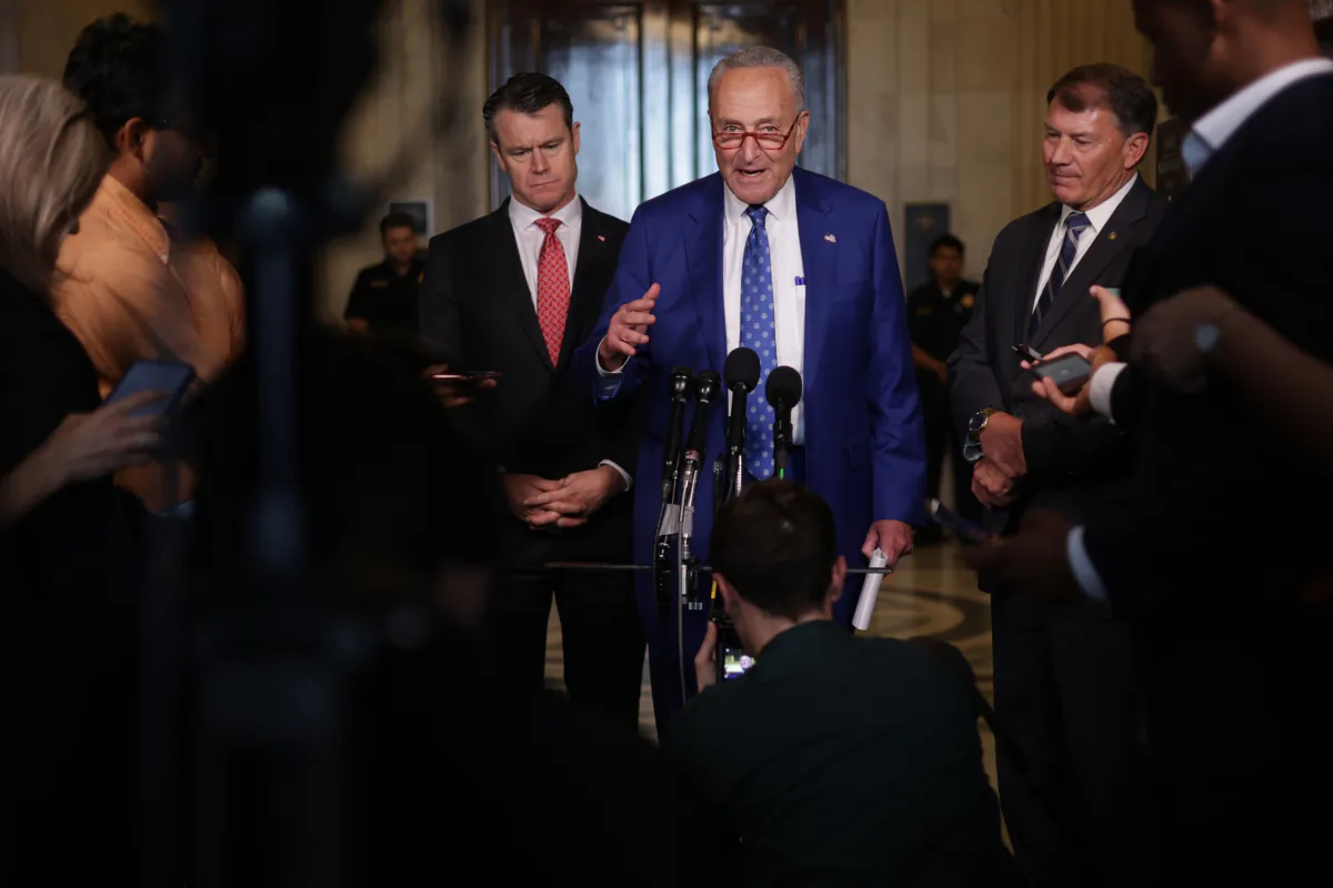 Senate Majority Leader Sen. Chuck Schumer (D-N.Y.) speaks to members of the press as Sen. Todd Young (R-Ind.) and Sen. Michael Rounds (R-S.D.) listen outside the “AI Insight Forum” at the Russell Senate Office Building on Capitol Hill in Washington on Sept. 13, 2023. (Alex Wong/Getty Images)