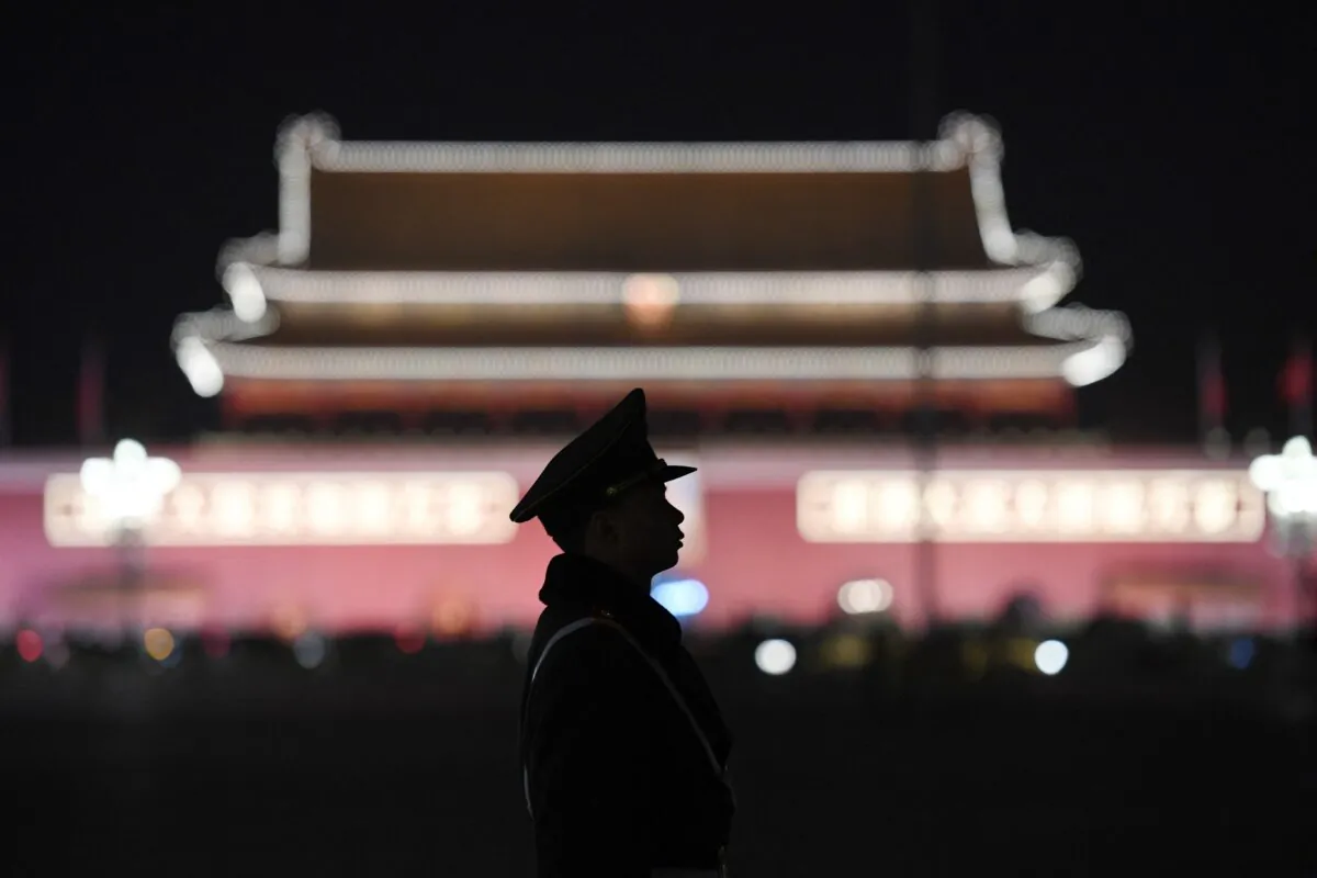 A paramilitary police officer stands guard in Tiananmen Square after a plenary session of the National People's Congress in the adjacent Great Hall of the People in Beijing on March 11, 2018. (GREG BAKER/AFP via Getty Images)