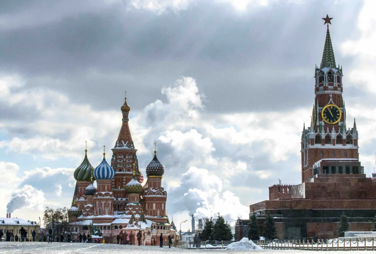 People walk in front of St. Basil's Cathedral and the Kremlin on Red Square in Moscow on March 16, 2018. (MLADEN ANTONOV/AFP via Getty Images)