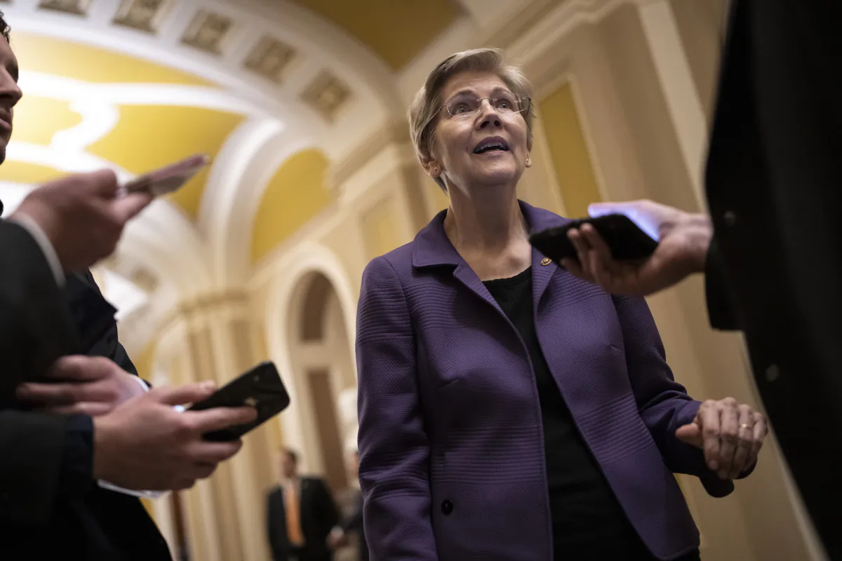 Sen. Elizabeth Warren (D-Mass.) speaks with reporters on her way to a closed-door lunch meeting with Senate Democrats at the U.S. Capitol in Washington on March 22, 2023. (Drew Angerer/Getty Images)