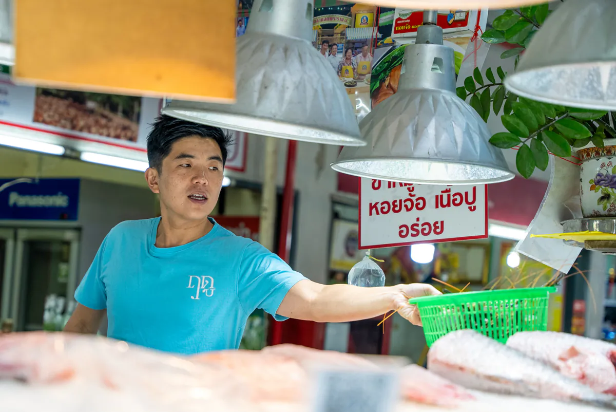 Chef Ton shopping at a local market, where he buys a basket of shrimp from one of the vendors. (Cody Long/Los Angeles Times/TNS)