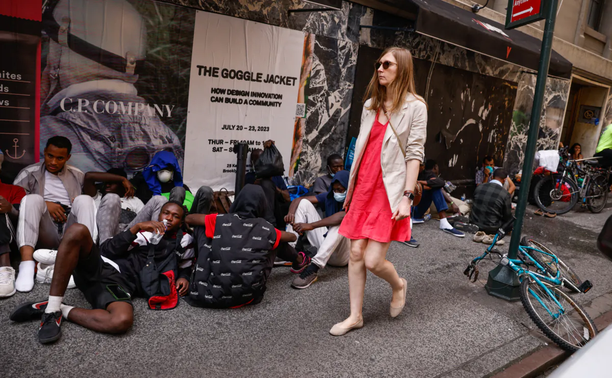 Migrants wait outside the Roosevelt Hotel, which has been turned into a migrant reception center, in midtown Manhattan, New York City, on July 31, 2023. (Kena Betancur/AFP via Getty Images)