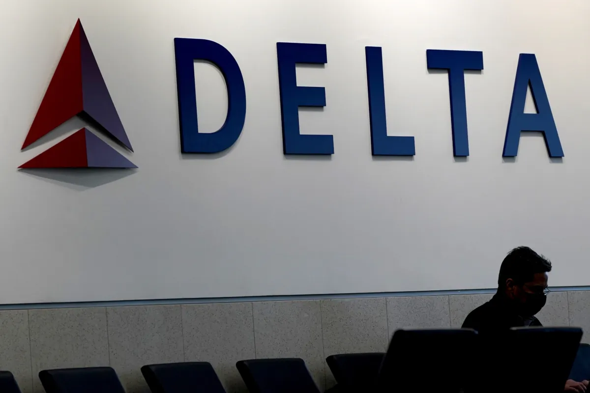 A man waits for a Delta Airlines flight at Hartsfield-Jackson International Airport in Atlanta on Jan. 7, 2022. (Charlie Riedel/AP Photo)