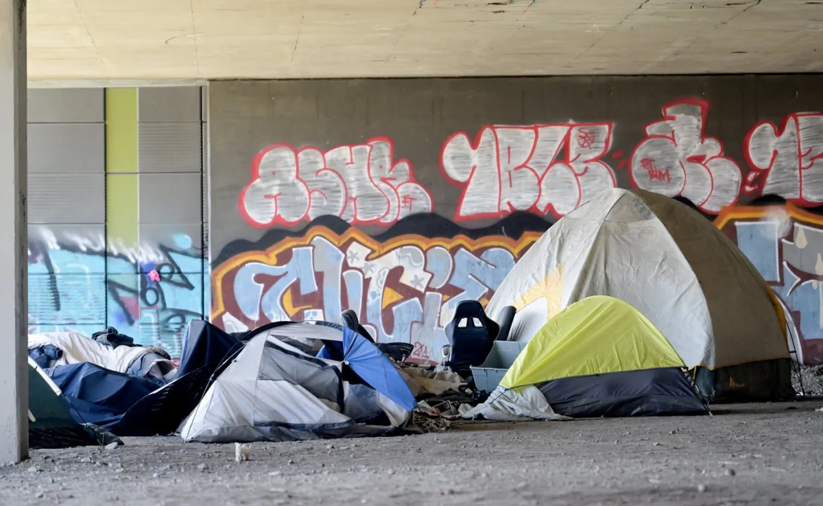 A homeless camp is shown beneath an overpass in Montreal on April 14, 2023. (The Canadian Press/Graham Hughes)