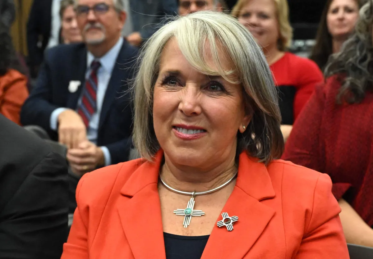 New Mexico Gov. Michelle Lujan Grisham listens to President Joe Biden's speech about student debt relief at Central New Mexico Community College Student Resource Center in Albuquerque, N.M., on Nov. 3, 2022. (Saul Loeb/AFP via Getty Images)