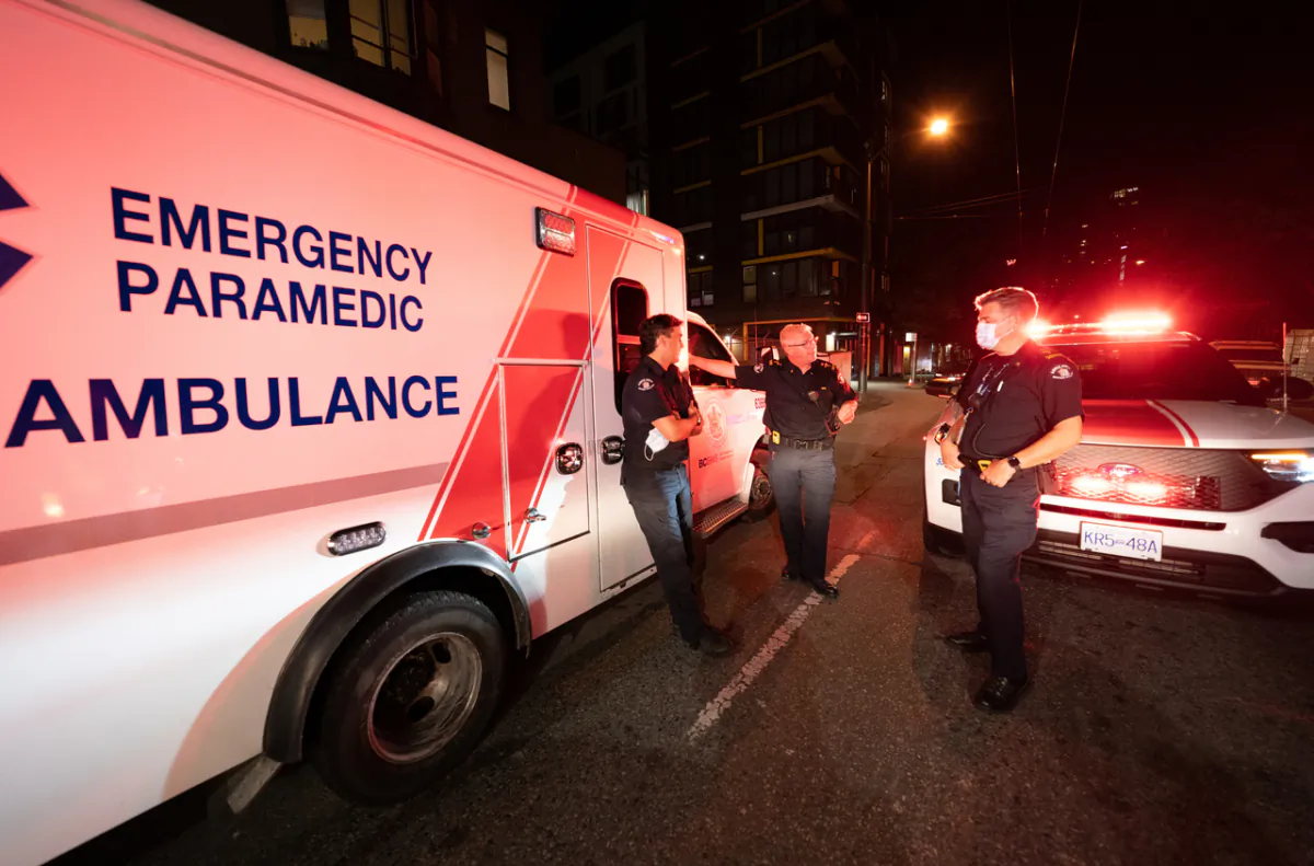 Paramedics debrief after responding to a drug overdose in Vancouver on June 23, 2021. (The Canadian Press/Jonathan Hayward)