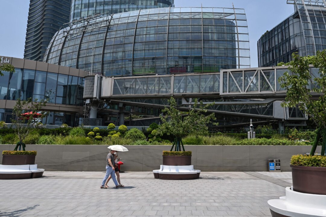 Removed company signage (top L) in a general view of the unoccupied Evergrande Center building in Shanghai on July 27, 2022. (Hector Retamal/AFP via Getty Images)