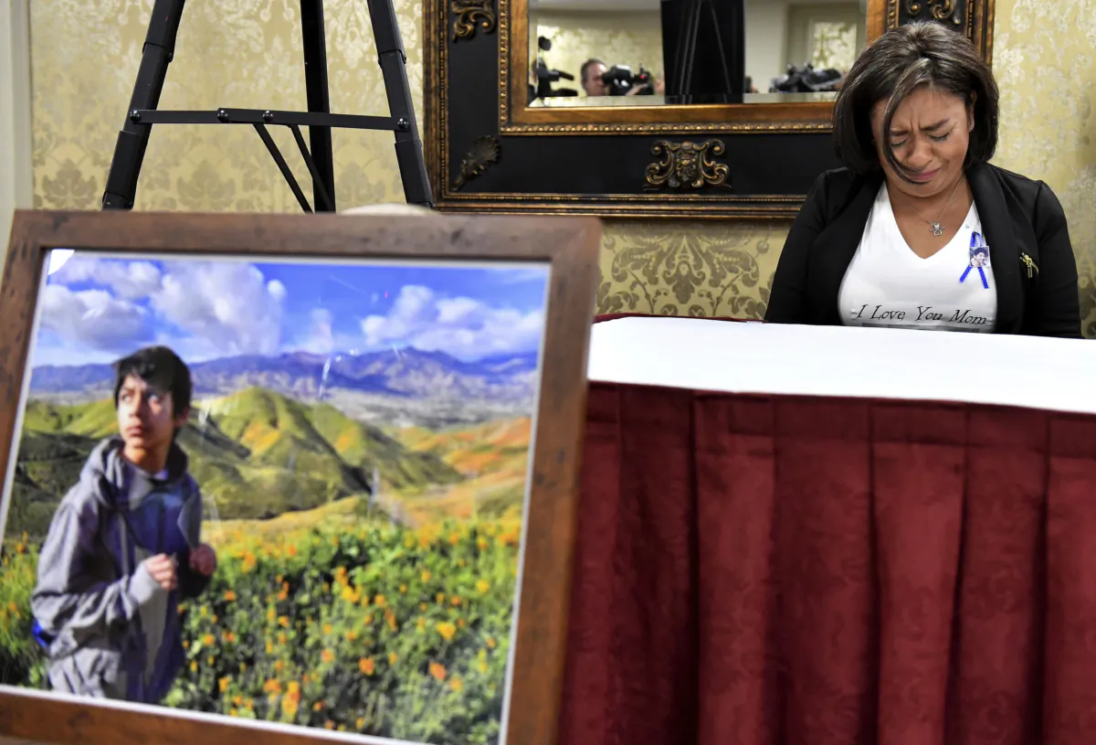 Juana Salcedo, aunt and guardian of 13-year-old Diego Stolz, cries during a news conference in Riverside, Calif., on Oct. 29, 2019, announcing the family has started legal proceedings against the Moreno Valley Unified School District. (Will Lester/The Orange County Register via AP)