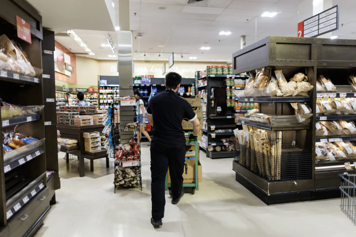 A worker at a Metro grocery store in Toronto on July 18, 2023. (The Canadian Press/Cole Burston)