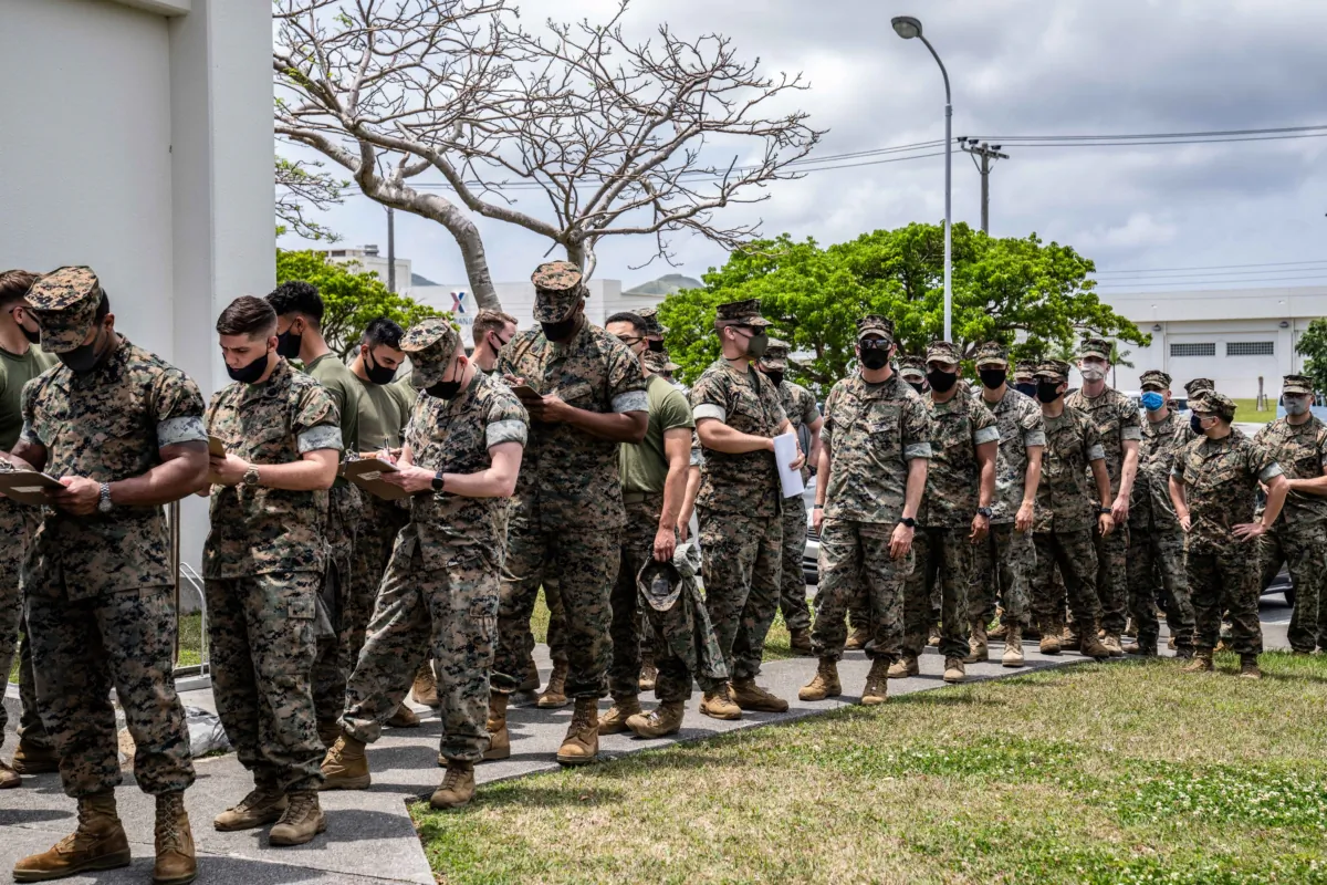 Members of the The United States Marine Corps wait in line to receive the Moderna COVID-19 vaccine at Camp Hansen in Kin, Japan, on April 28, 2021. (Carl Court/Getty Images)