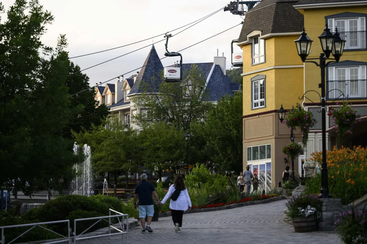 People walk at Mont-Tremblant Resort in Mont-Tremblant, Que., on July 16, 2023. (The Canadian Press/Justin Tang)