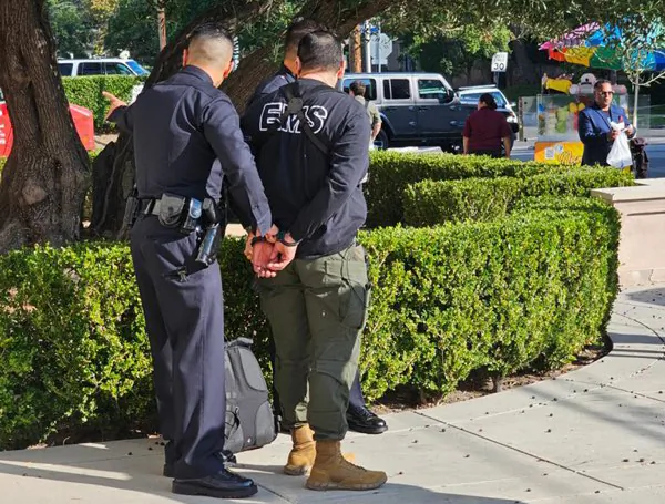 A man is taken into police custody outside an event at which Democratic presidential candidate Robert F. Kennedy Jr. was scheduled to speak at Wilshire Ebell Theatre in Los Angeles on Sept. 15, 2023. (Provided to The Epoch Times)