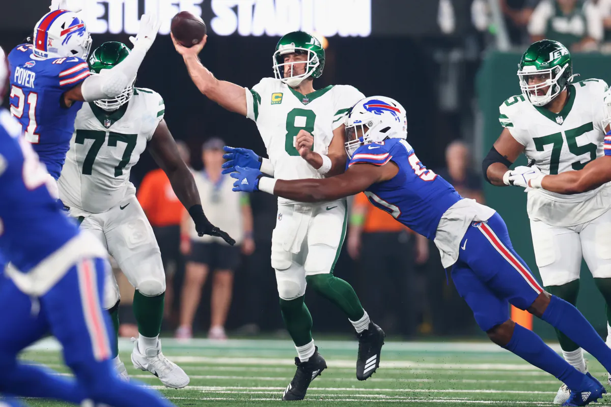 Aaron Rodgers (8) of the New York Jets passes as Greg Rousseau (50) of the Buffalo Bills defends in the first quarter of the NFL game at MetLife Stadium in East Rutherford, N.J., on Sept. 11, 2023. (Mike Stobe/Getty Images)