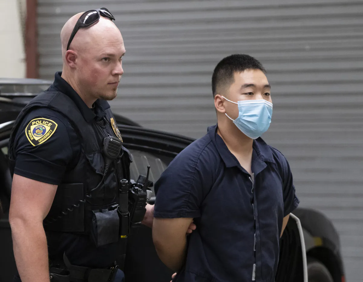 Purdue University police transport murder suspect Ji Min Sha at Tippecanoe County Jail in Lafayette, Ind., Oct. 5, 2022. (Alex Martin/Journal & Courier via AP)