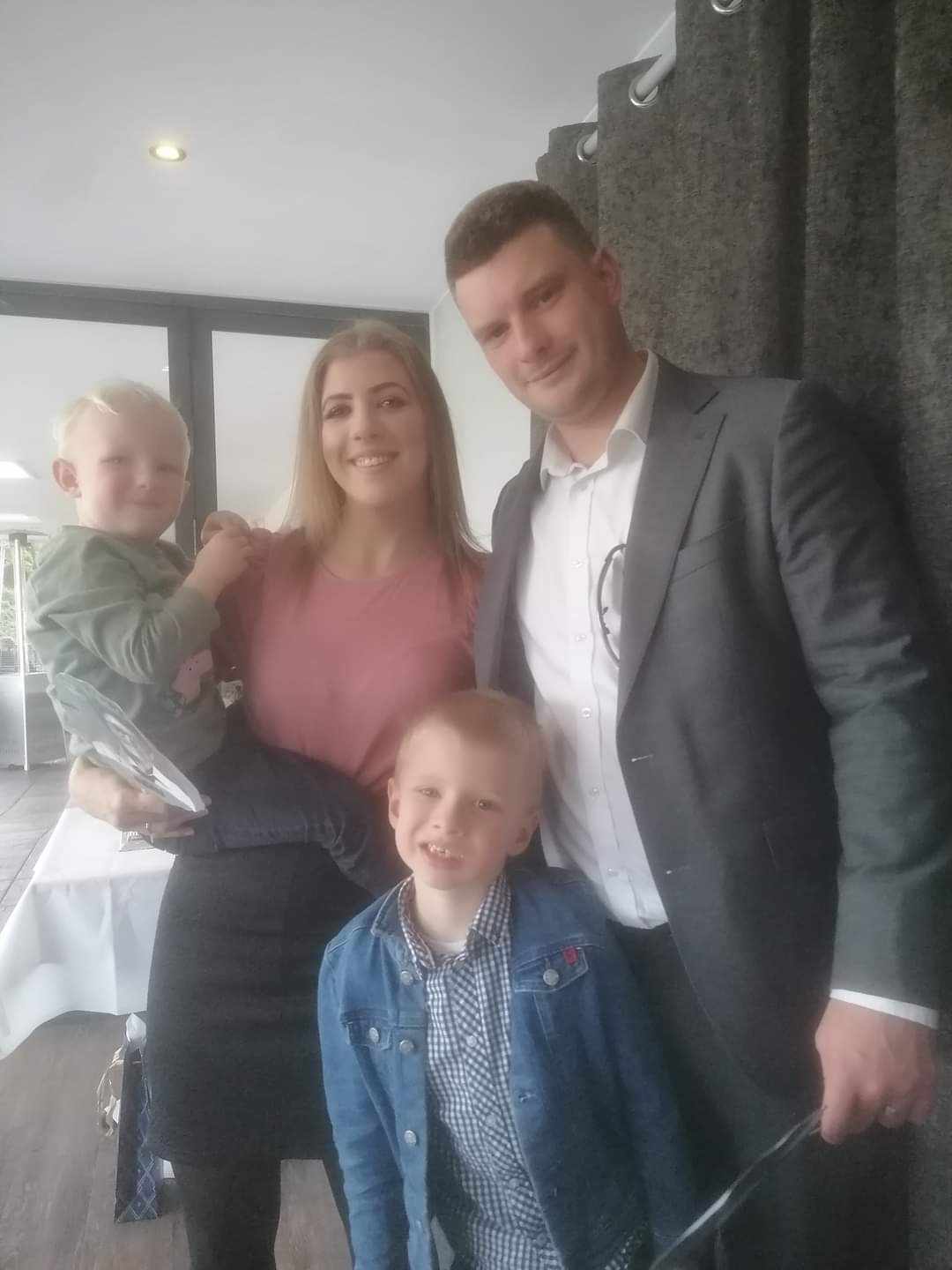 Ms. Reid with her husband and sons.