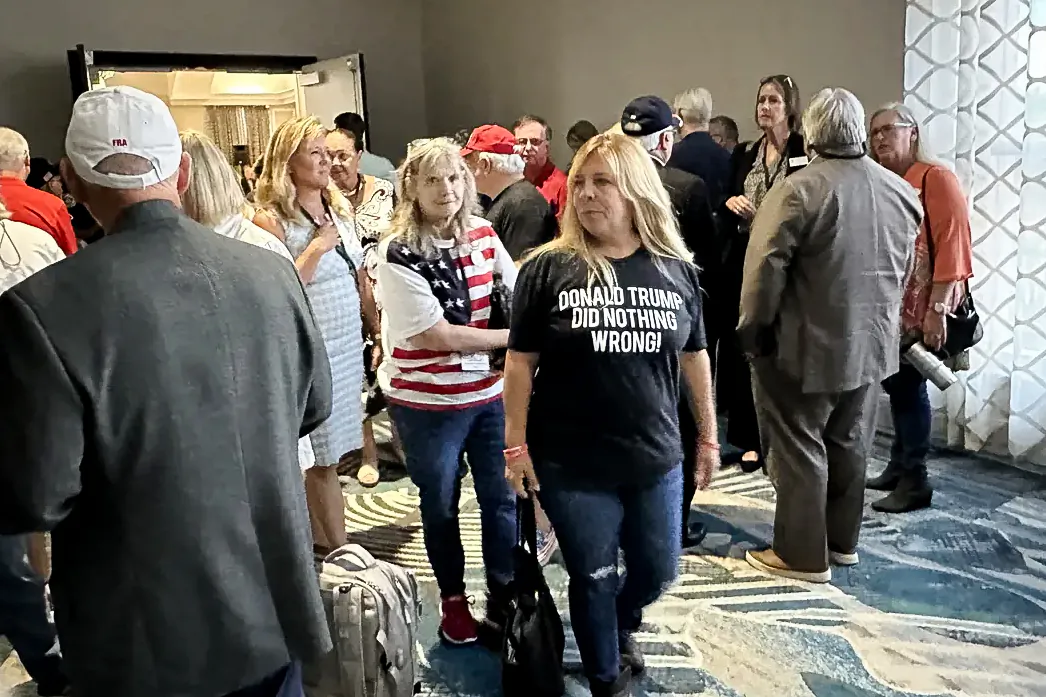 People in the hallway of the Rosen Centre Hotel in Orlando, Fla., outside a closed-door meeting at which the state Republican Party officials were debating whether to remove a loyalty oath for those seeking to enter the GOP primary. (The Epoch Times)