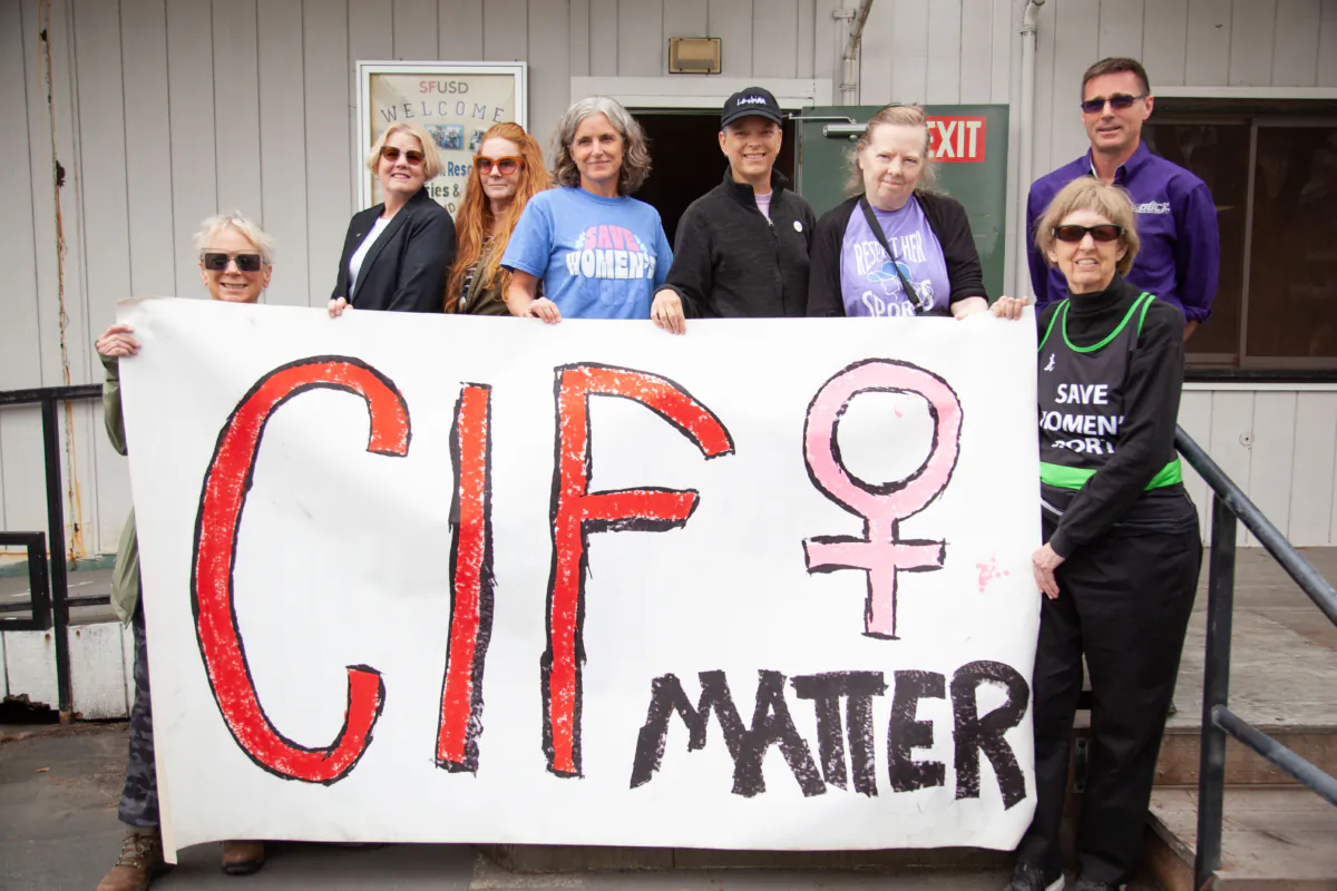 A women’s rights group protests in front of a San Francisco Unified School District building. (Lear Zhou/The Epoch Times)