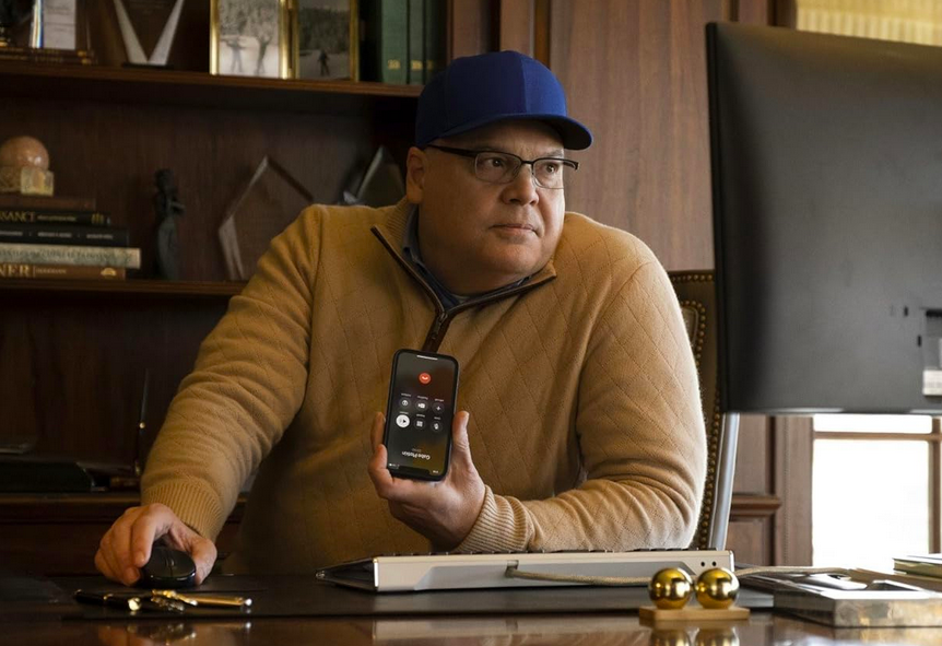 man in brown shirt and blue hat in DUMB MONEY