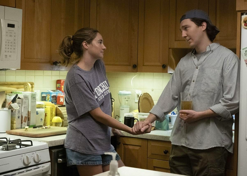 man and woman in kitchen in DUMB MONEY