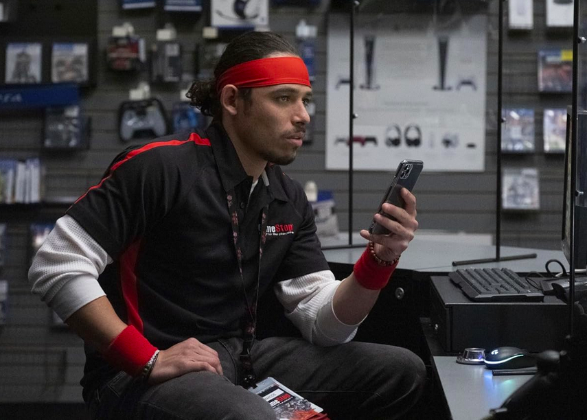 man with red head band and phone in DUMB MONEY