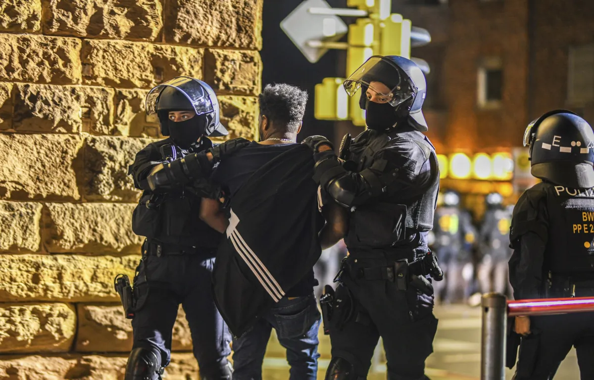 A man is taken away by police officers in Stuttgart, Baden-Württemberg, Germany, on Sept. 16, 2023, after clashes at a gathering of Eritrean groups. (Jason Tschepljakow/dpa via AP)