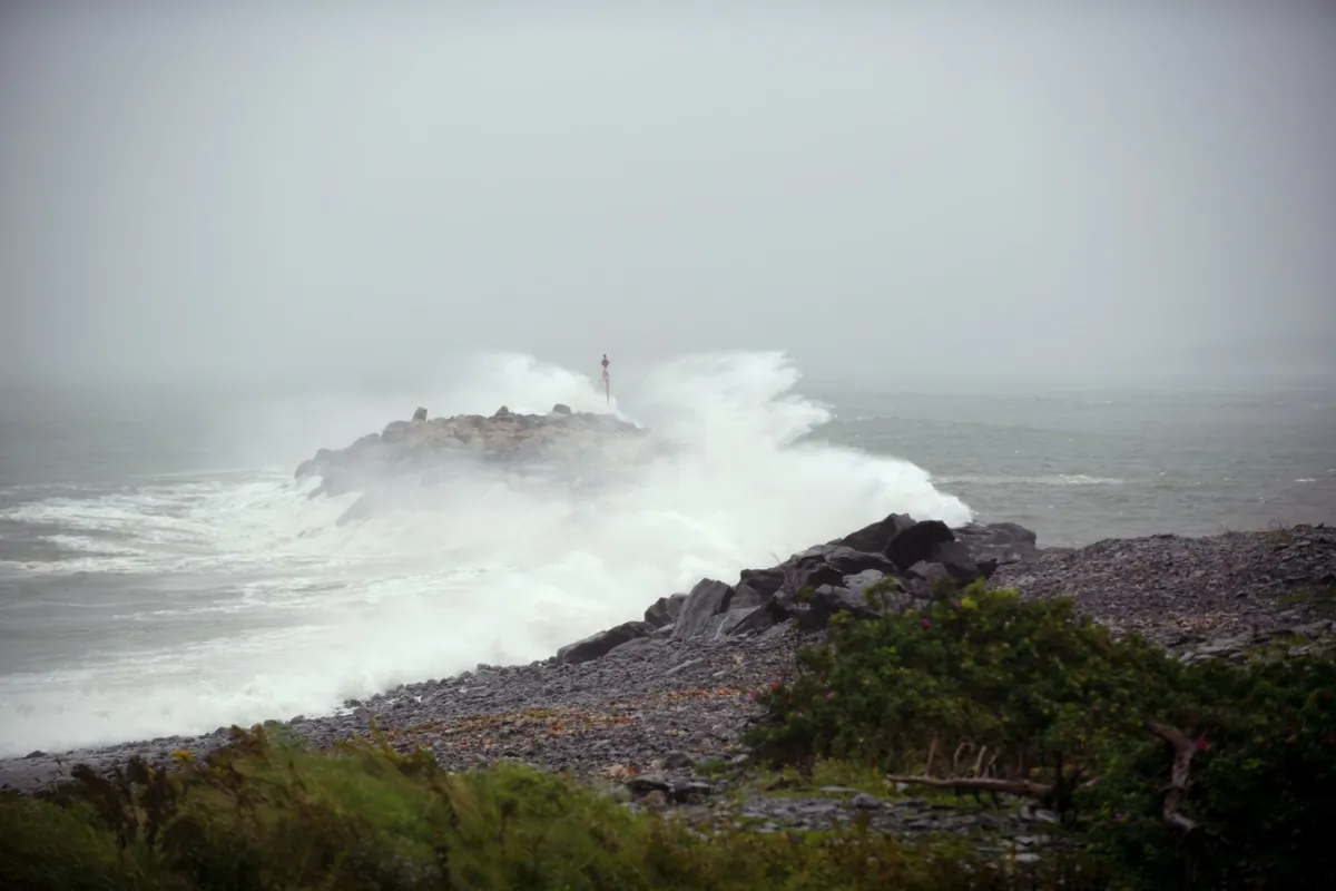 Waves crash against a breakwater in Port Maitland, N.S. as post-tropical cyclone Lee approaches on Sept. 16, 2023. (The Canadian Press/Bill Curry)