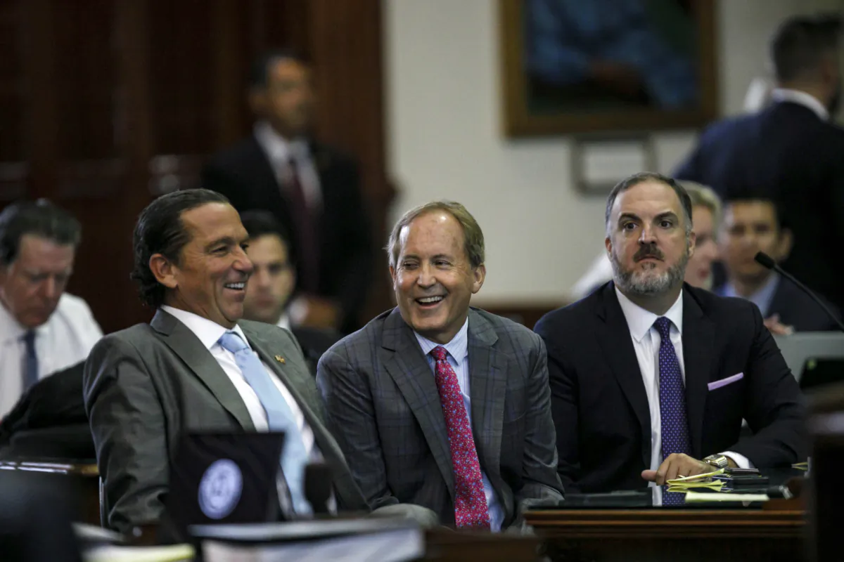 Texas Attorney General Ken Paxton (C) sits between defense attorneys Tony Buzbee (L) and Mitch Little (R) before his impeachment trial resumes in the Senate Chamber at the Texas Capitol in Austin on Sept. 15, 2023. (Sam Owens/The San Antonio Express-News via AP, Pool)