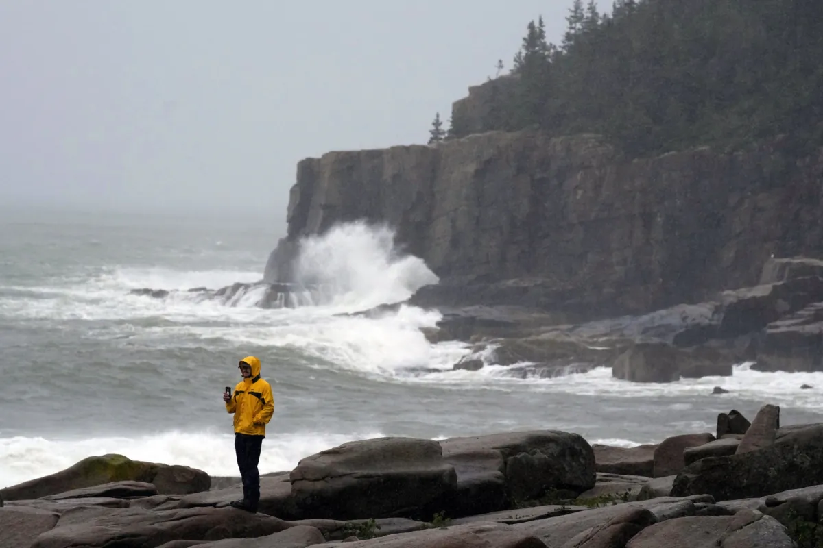 Chris Crawford, of Mount Desert Island, Maine, films the raging surf near Otter Point in Acadia National Park as severe weather associated with storm Lee pounds the region in Bar Harbor, Maine, on Sept. 16, 2023. (Robert F. Bukaty/AP Photo)