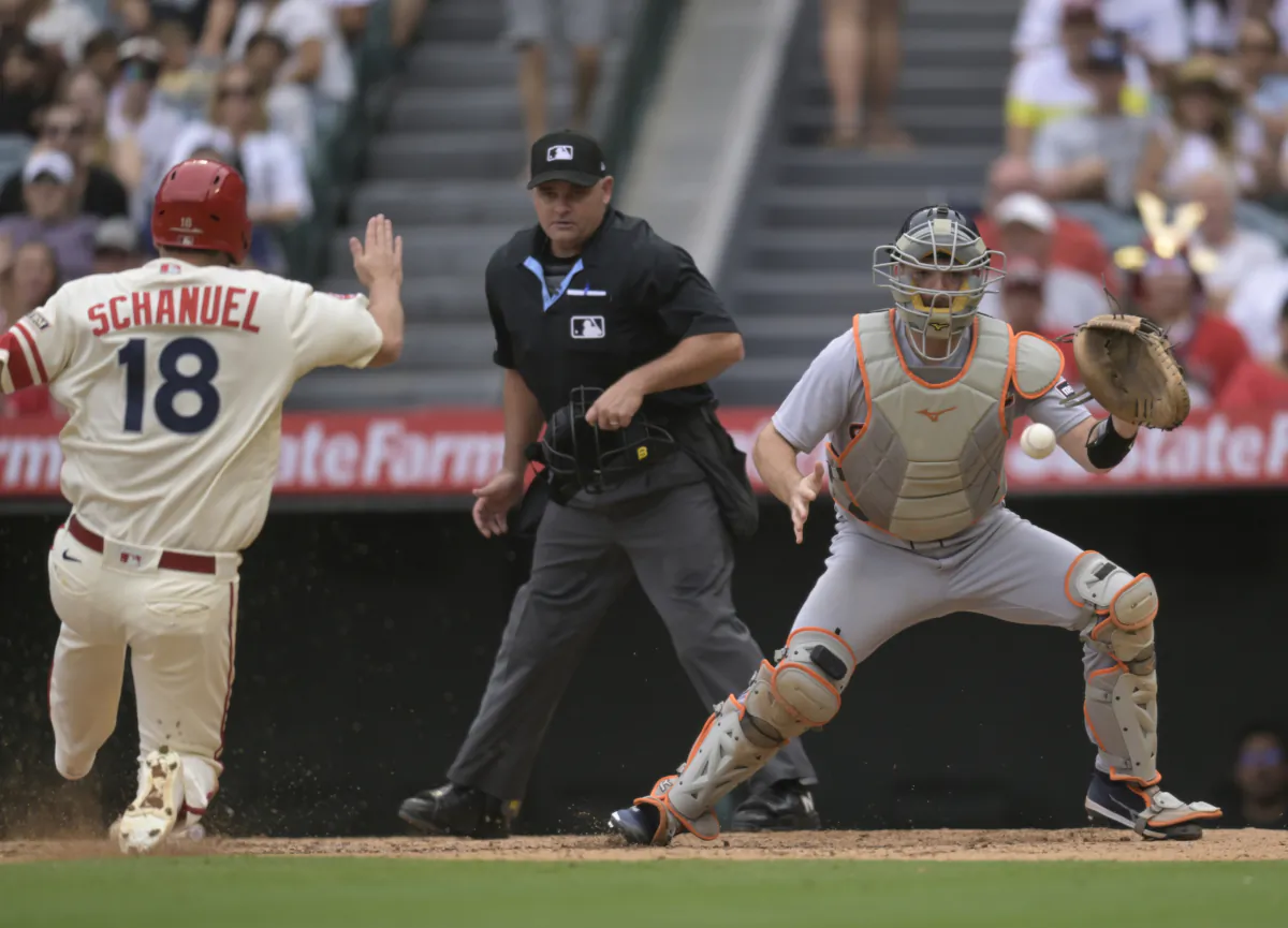 Nolan Schanuel (18) of the Los Angeles Angels gets to home plate before Jake Rogers (34) of the Detroit Tigers can make a tag in the fifth inning at Angel Stadium of Anaheim in Anaheim, Calif., on Sept. 17, 2023 (John McCoy/Getty Images)