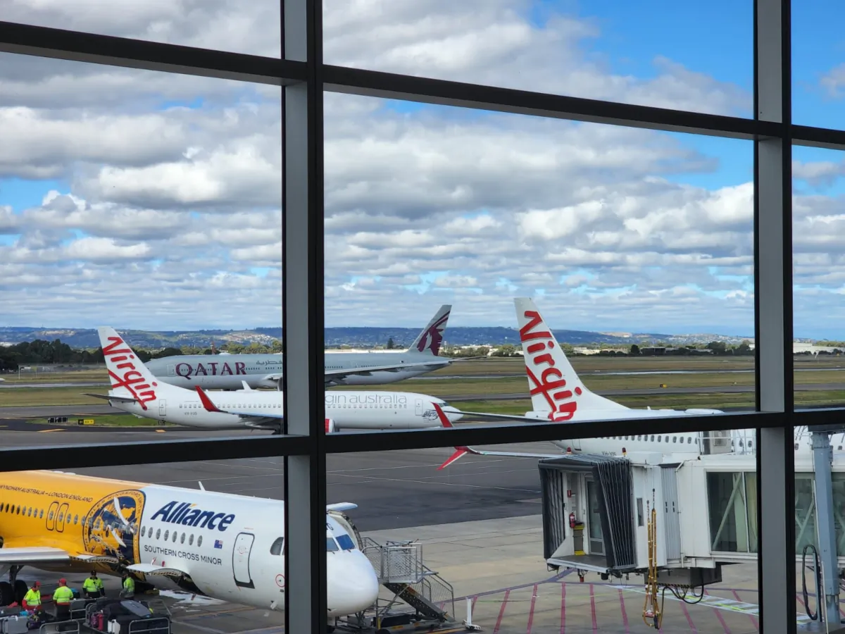 Virgin, Qatar, and Alliance planes can be seen at Adelaide Airport in South Australia on April 10, 2023. (Susan Mortimer/The Epoch Times)