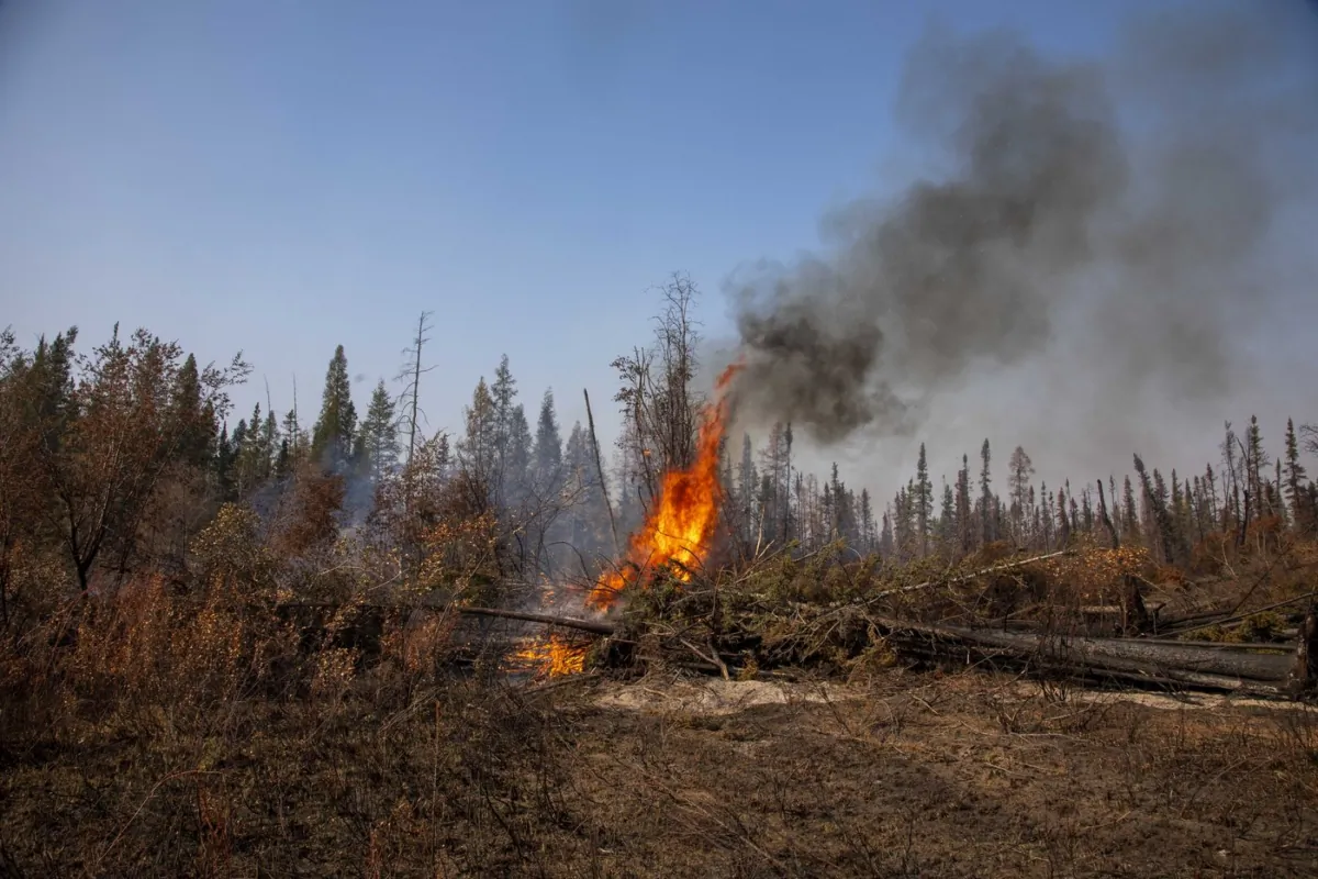 Small spot fires continued to flare up alongside Northwest Territories highways leading into Hay River, Fort Smith and Yellowknife, on Sept. 15, 2023. (The Canadian Press/Bill Braden)