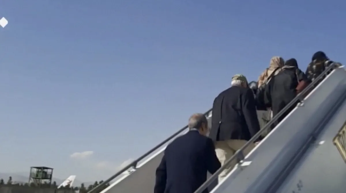 Released U.S. detainees board a plane in Tehran, Iran, heading to Doha, Qatar, on Sept. 18, 2023, in a still from video. (Pool via WANA via Reuters/Screenshot via The Epoch Times)