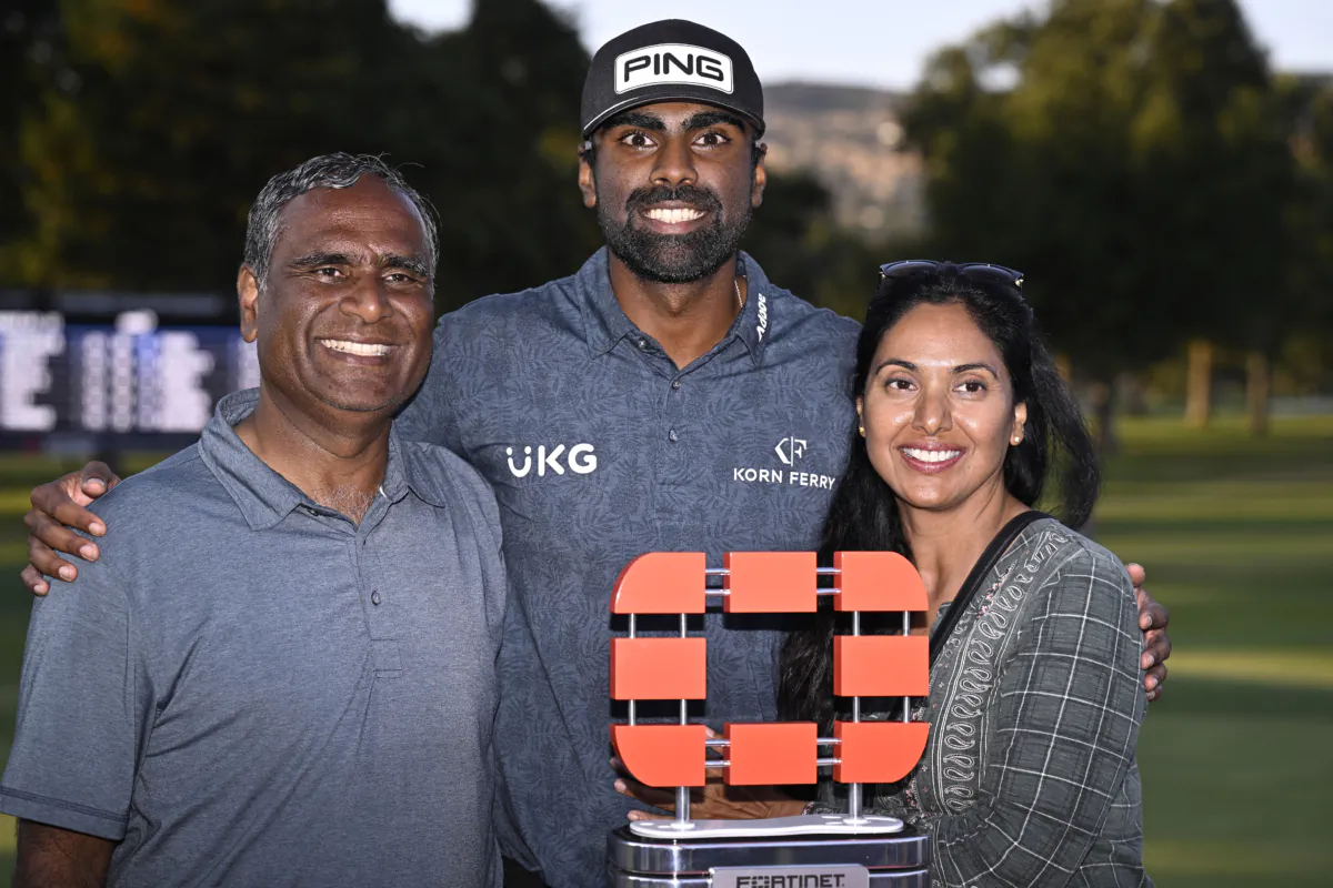 Sahith Theegala (C) of the United States, his mother Karuna Theegala (R) and his father Muralidhar Theegala (L) celebrate with the trophy after winning during the final round of the Fortinet Championship at Silverado Resort and Spa in Napa, Calif., on Sept. 17, 2023. (Orlando Ramirez/Getty Images)