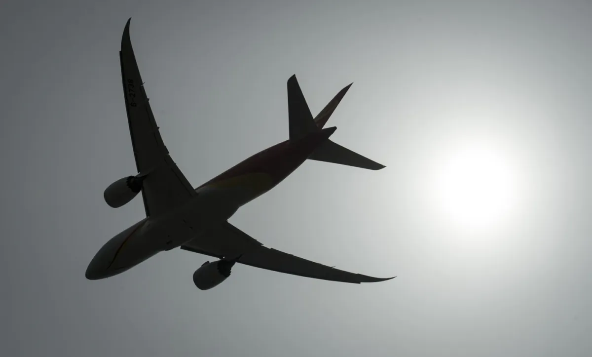 A plane is silhouetted as it takes off from Vancouver International Airport in Richmond, B.C., on May 13, 2019. (The Canadian Press/Jonathan Hayward)