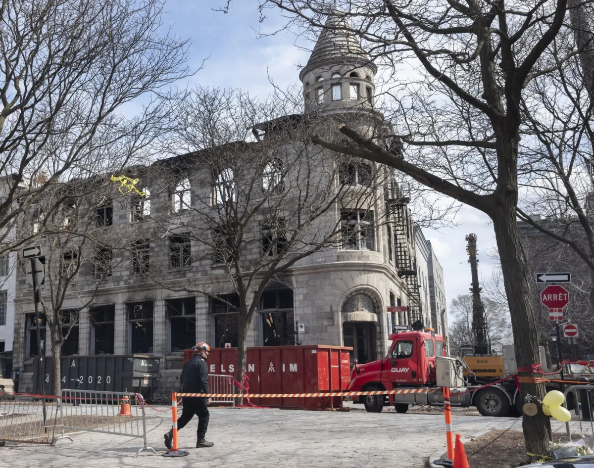 The search continues at the scene of a fire in a heritage building in Old Montreal on March 27, 2023. (The Canadian Press/Ryan Remiorz)