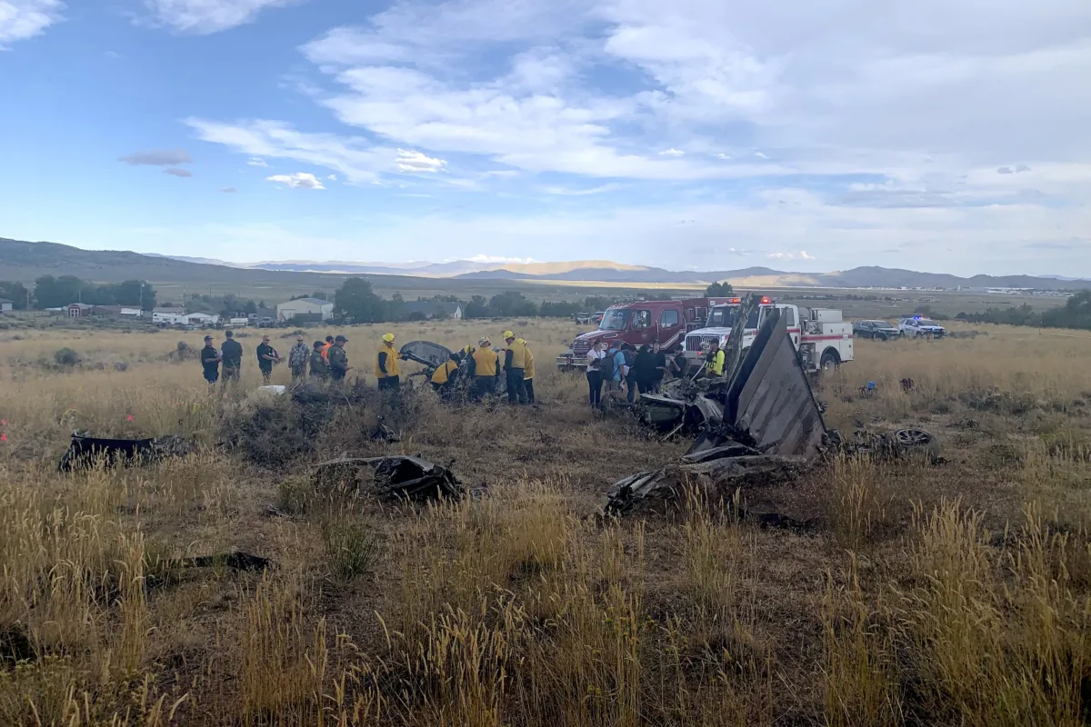 Members of the Truckee Meadows Fire and Rescue Department and other officials look over aircraft wreckage in Reno, Nev., on Sept. 17, 2023, after two California pilots were killed when their planes collided in mid-air while preparing to land after completing a race at the National Championship Air Races north of Reno. (Adam R. Mayberry/Truckee Meadows Fire and Rescue via AP)