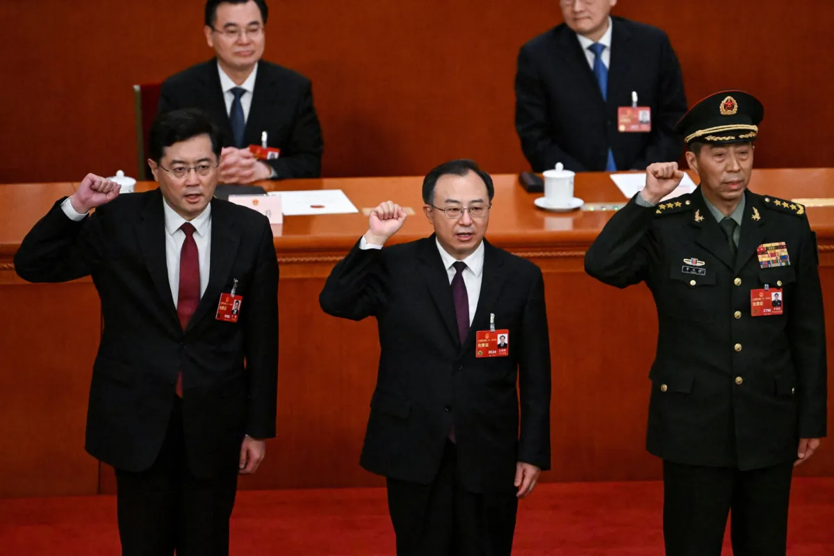 (L-R) Chinese State Councilor Qin Gang, State Councilor and Secretary-General of the State Council Wu Zhenglong, and State Councilor Li Shangfu swear an oath after they were 'elected' during the fifth plenary session of China's rubber-stamp legislature, the National People's Congress (NPC), at the Great Hall of the People in Beijing on March 12, 2023. (Noel Celis/AFP via Getty Images)