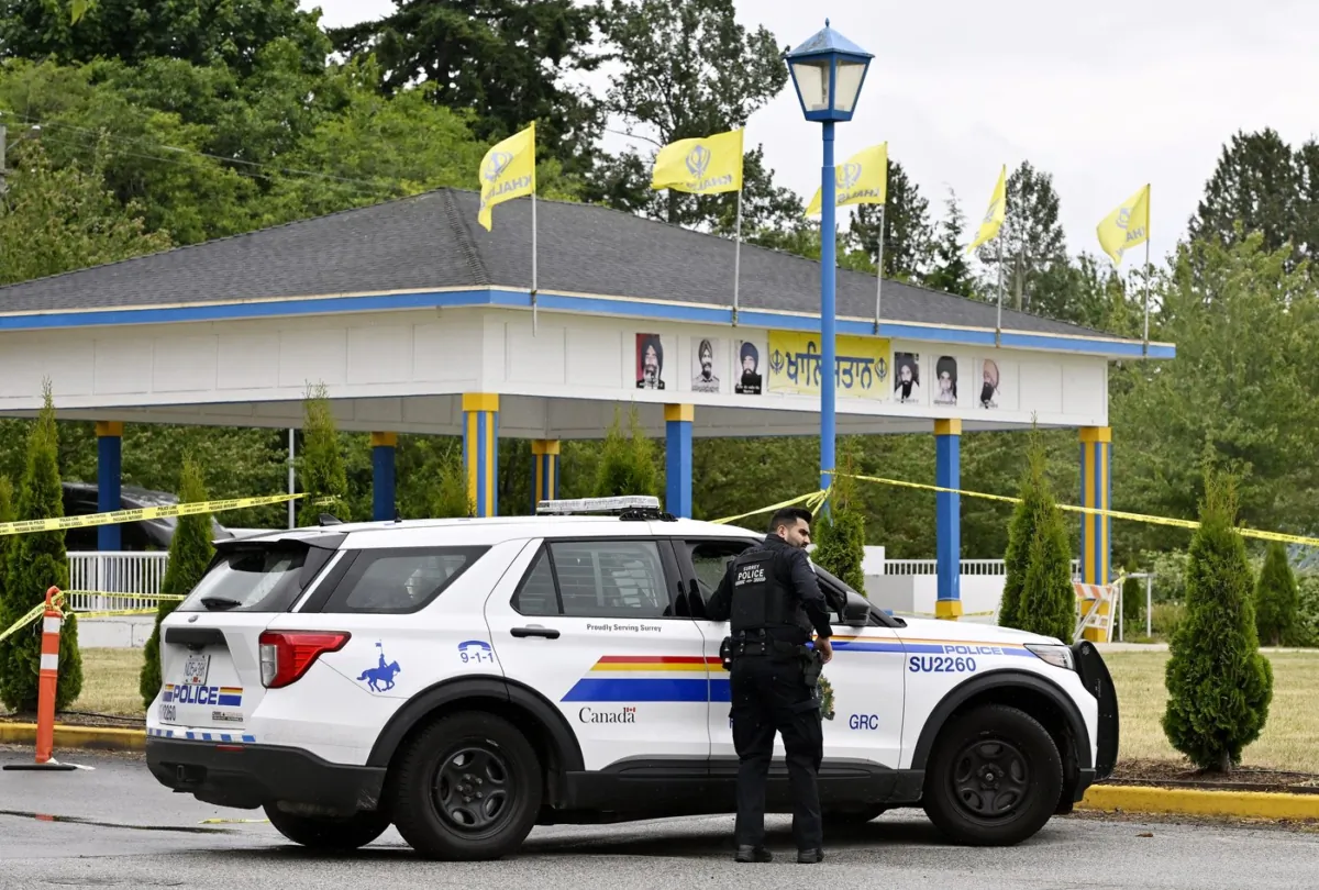Police officers attend the scene of a shooting outside of the Guru Nanak Sikh Gurdwara Sahib temple, in Surrey, B.C., on June 19, 2023. (The Canadian Press/Jennifer Gauthier)