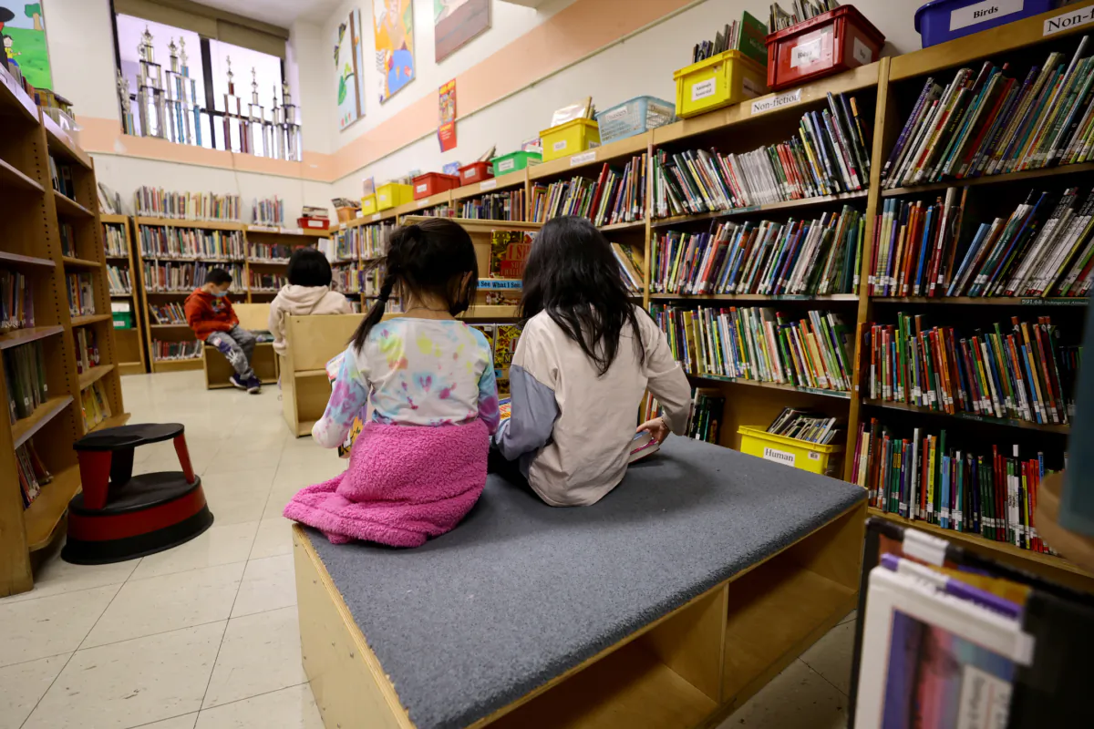 Students in the library receive candy and red envelopes in a cultural celebration of the Lunar New Year at a school in New York City on Feb. 2, 2022. (Michael Loccisano/Getty Images)