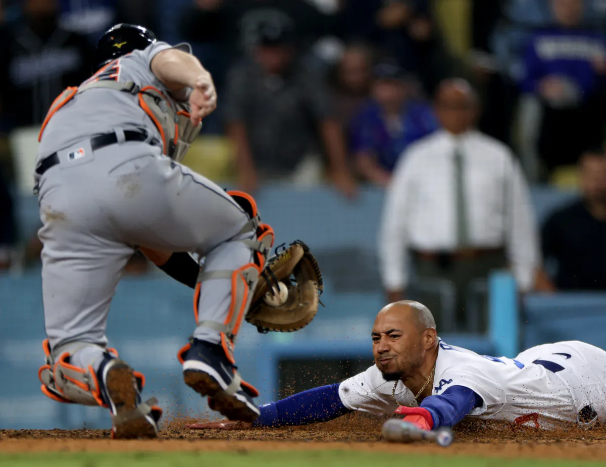 Mookie Betts (50) of the Los Angeles Dodgers reacts as he slides under the tag from Jake Rogers (34) of the Detroit Tigers, to score the game winning run during the ninth inning at Dodger Stadium in Los Angeles on September 19, 2023. (Harry How/Getty Images)
