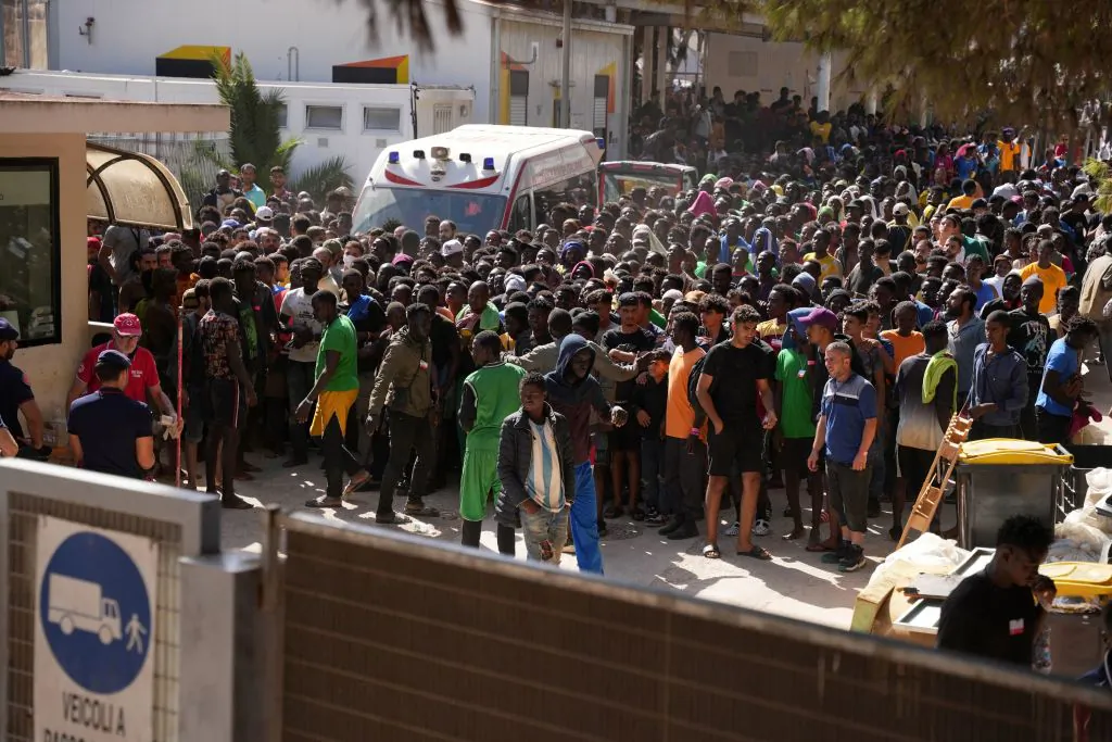 Illegal immigrants wait at the operational centre called the "Hotspot" to receive registration papers from the Red Cross on the Italian island of Lampedusa, on Sept. 17, 2023. (Zakaria Abdelkafi/AFP via Getty Images)