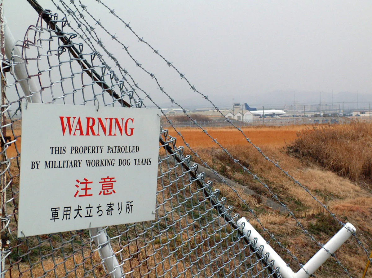 A military plane parks at the barbed-wired U.S. Marine Corps Air Station at Iwakuni city in Yamaguchi prefecture near Hiroshima Feb. 10, 2006. (Shingo Ito /AFP via Getty Images)