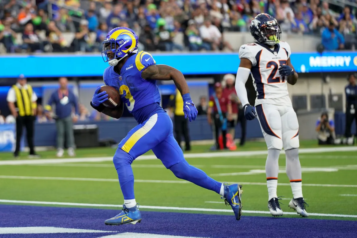 Los Angeles Rams running back Cam Akers scores past Denver Broncos cornerback Damarri Mathis during the first half of an NFL football game in Inglewood, Calif., on Dec. 25, 2022. (Jae C. Hong/AP Photo)