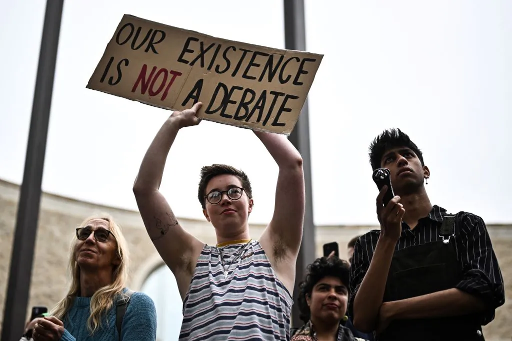 Pro-transgender activists hold placards during a gathering in Oxford, on May 30, 2023. (Photo by Ben Stansall/AFP via Getty)