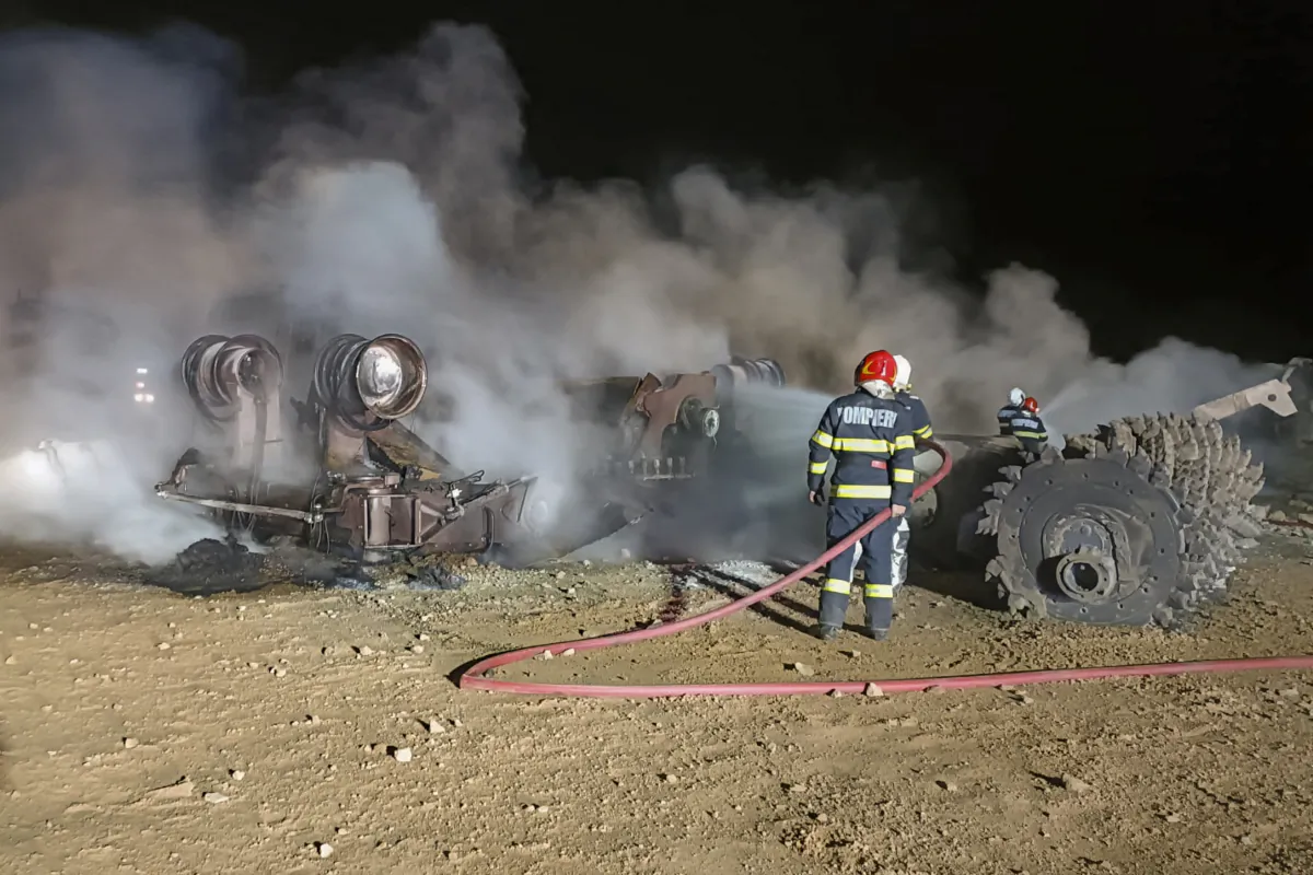 Firefighters work at the site of an explosion on a highway construction in the area of Calimanesti, eastern Romania, on Sept. 21, 2023. (ISU Vrancea via AP)