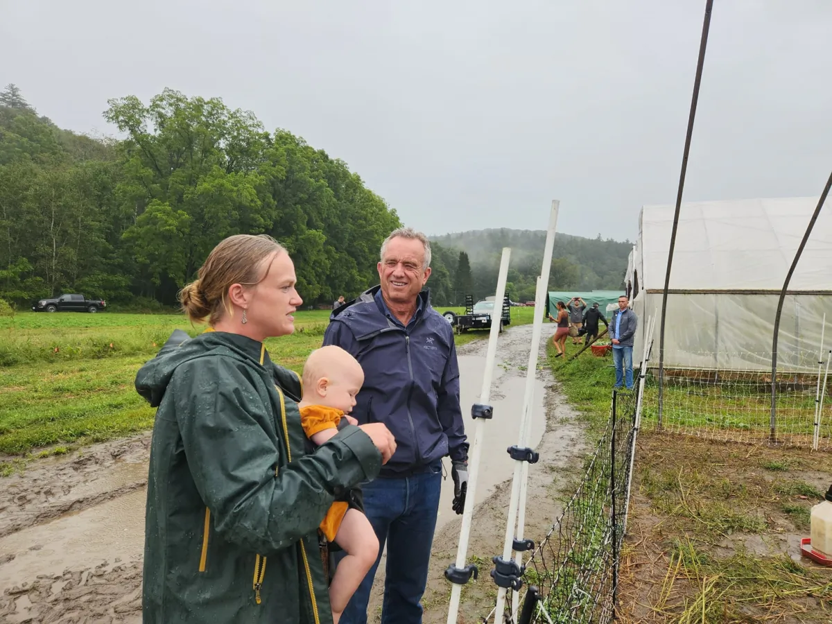 Robert F. Kennedy Jr. talks to a supporter at an organic farm in New Hampshire on Sept. 11., 2023 (Jeff Louderback/The Epoch Times)