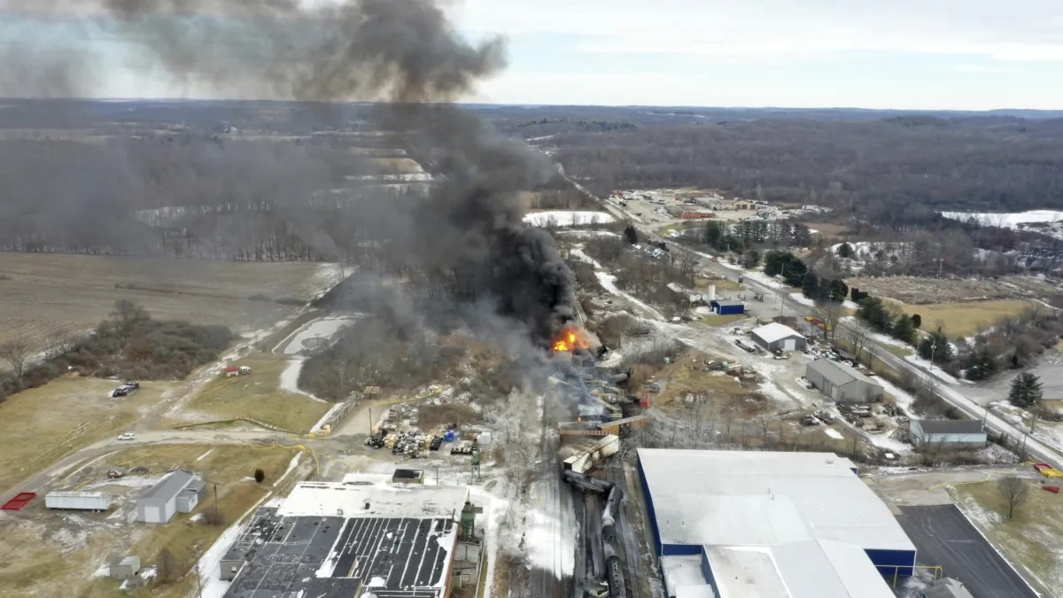 Portions of a Norfolk Southern freight train that derailed the night before in East Palestine, Ohio, on Feb. 4, 2023, still on fire at mid-day. (Gene J. Puskar/AP Photo)
